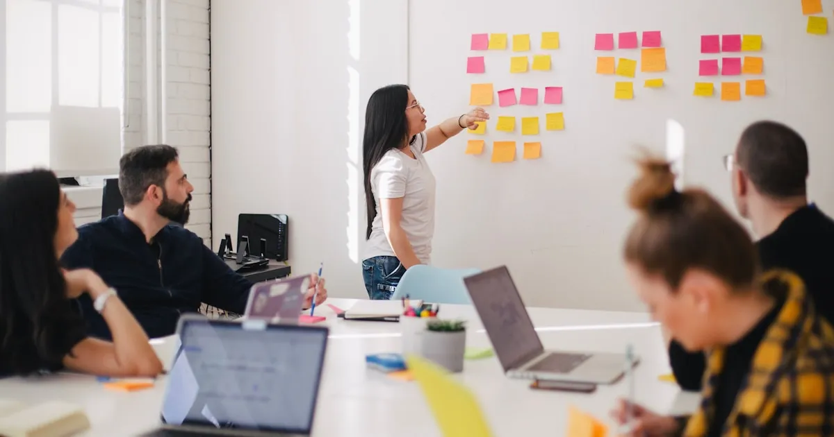 Business team planning ERP implementation at a whiteboard with process diagrams